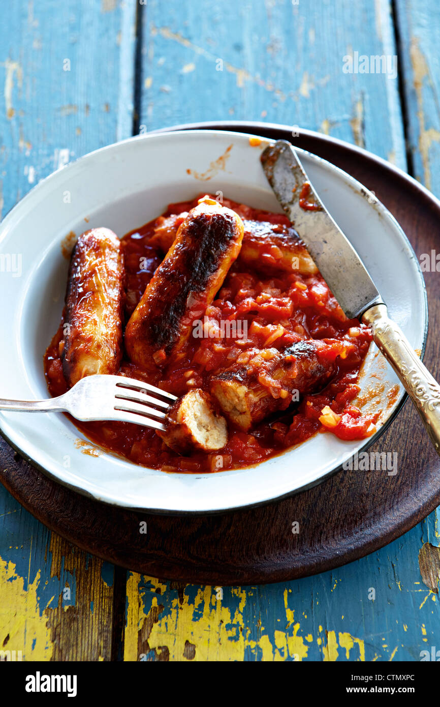 Pork sausages in tomato and onion sauce Stock Photo Alamy