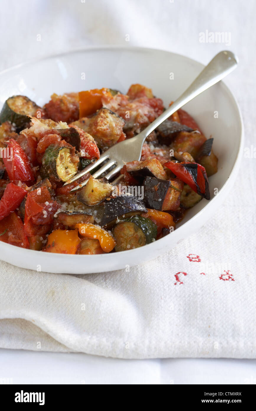 Oven-baked ratatouille with Parmesan crust. Ingredients: courgettes, aubergine, sweet peppers, garlic, tomatoes Stock Photo