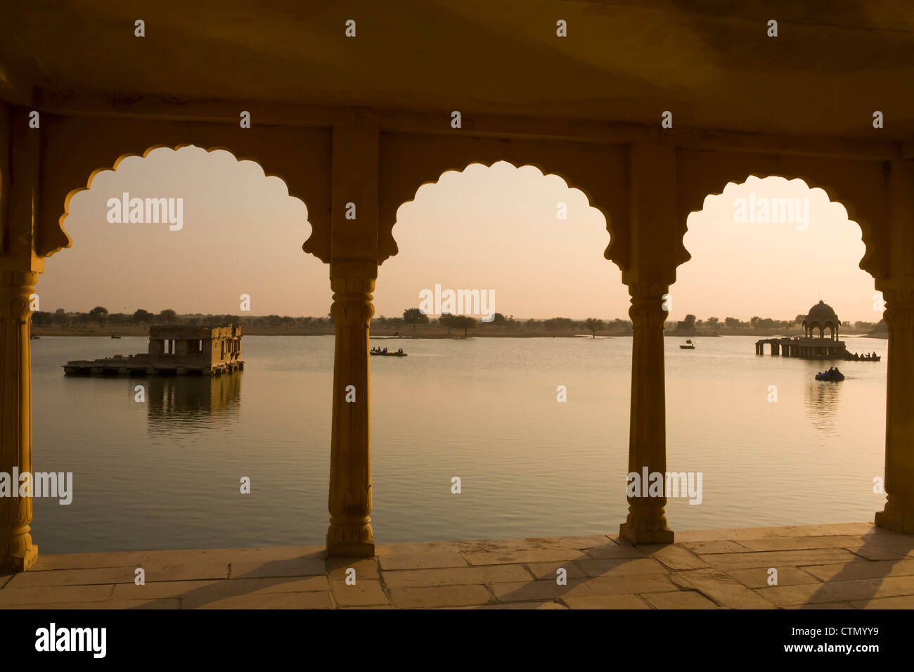 View through archways of the pavilions at Gadi Sagar Tank near Jaisalmer, Rajasthan, India. Stock Photo