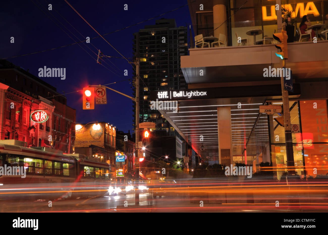 Night life on King Street East in Toronto including Tiff Bell Lightbox Festival Tower and trendy restaurants Stock Photo