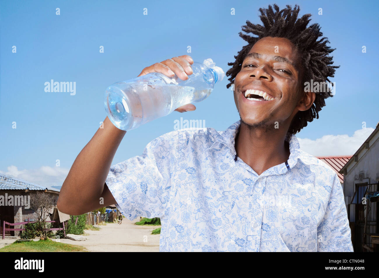 Portrait of an African man with a water bottle, Gugulethu, Cape Town Stock Photo