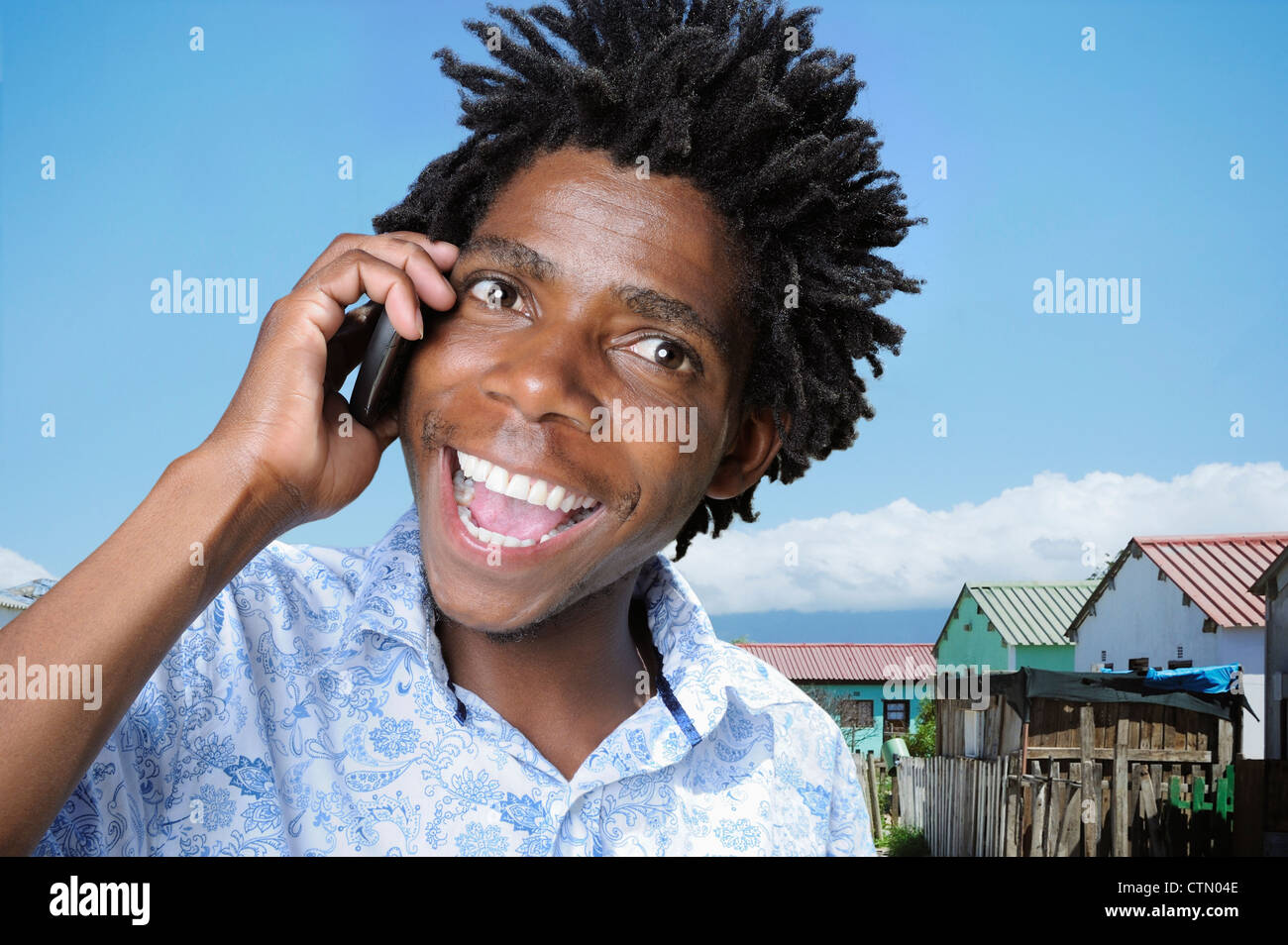 Portrait of an African man using a mobile phone, Gugulethu, Cape Town Stock Photo