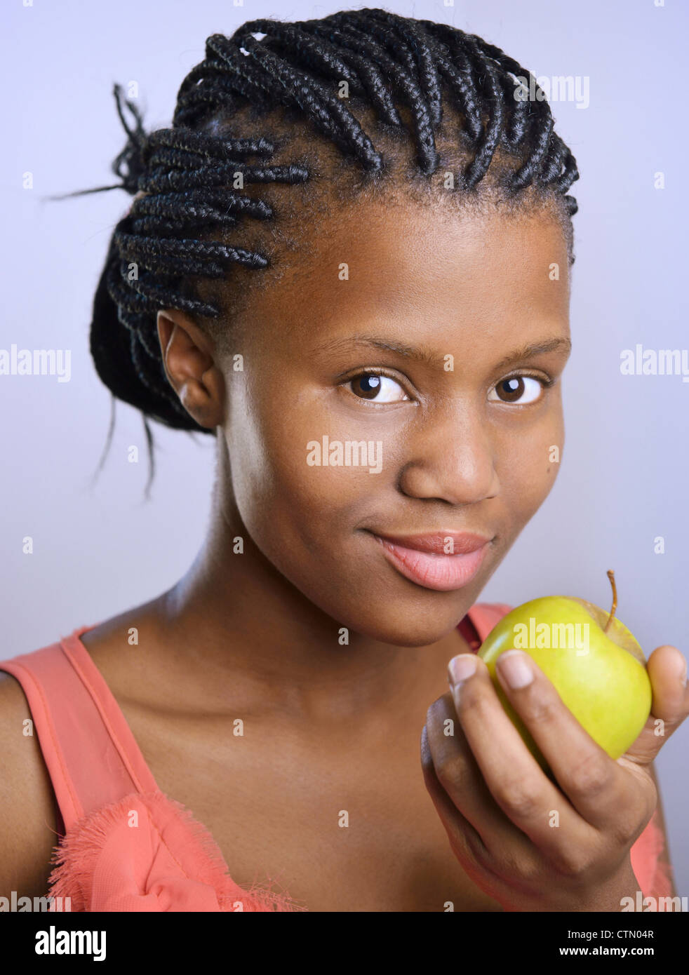 Portrait of a young African woman with an apple, Observatory, Cape Town Stock Photo
