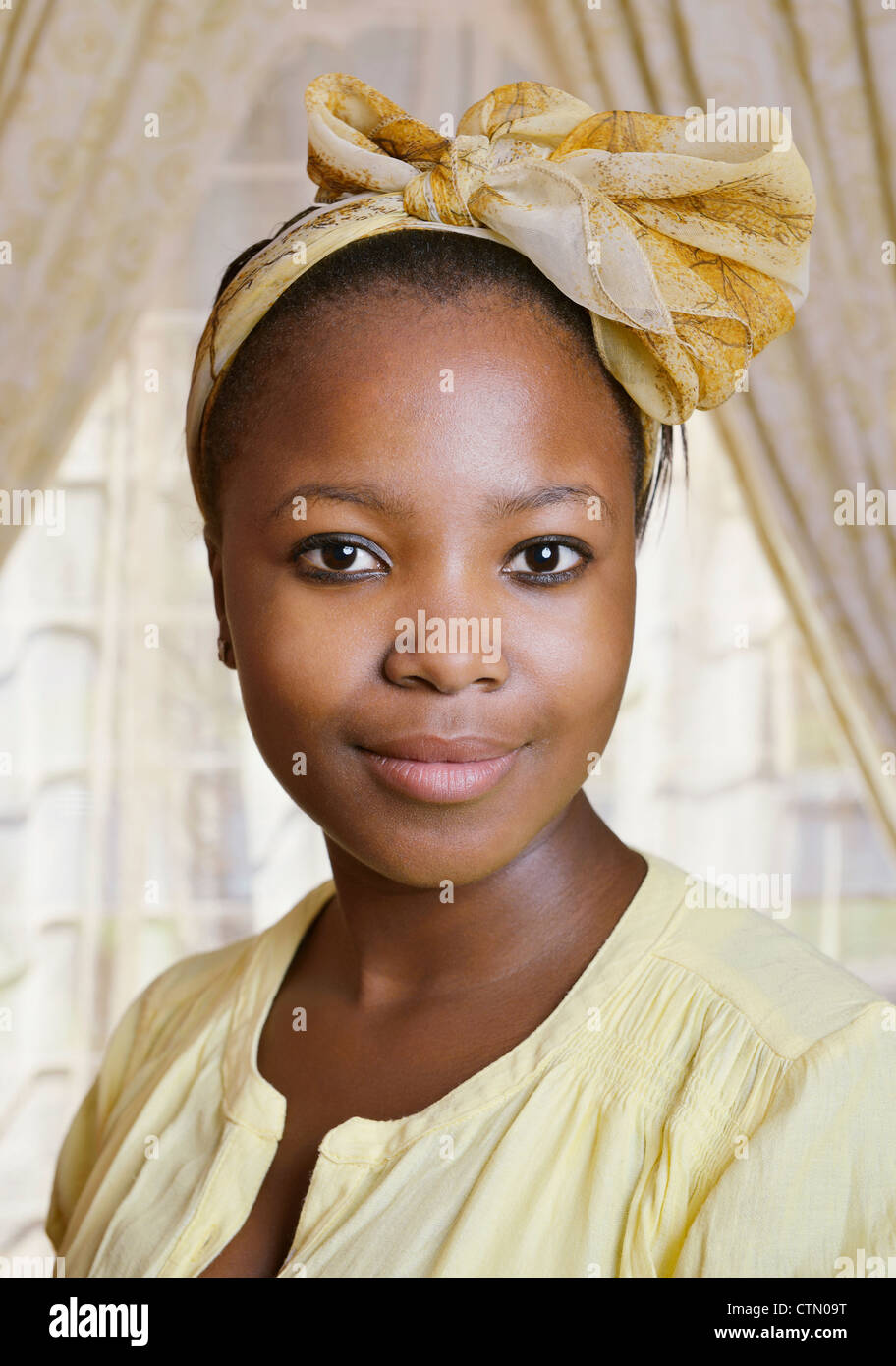 Portrait of a young African woman in yellow, Mandalay, Cape Town Stock Photo
