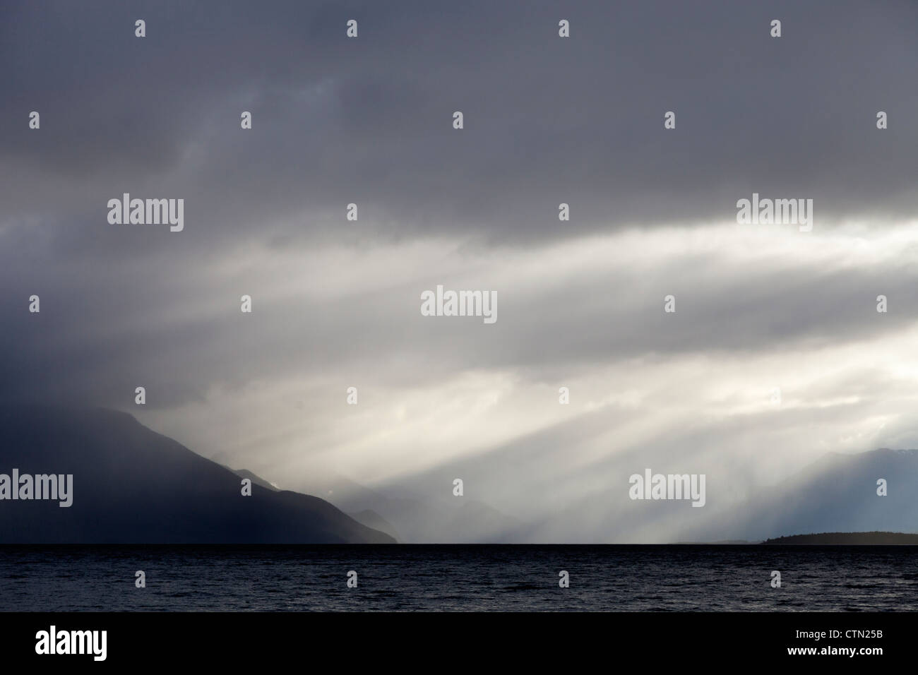 Breaking skies above Lake Te Anau, New Zealand Stock Photo