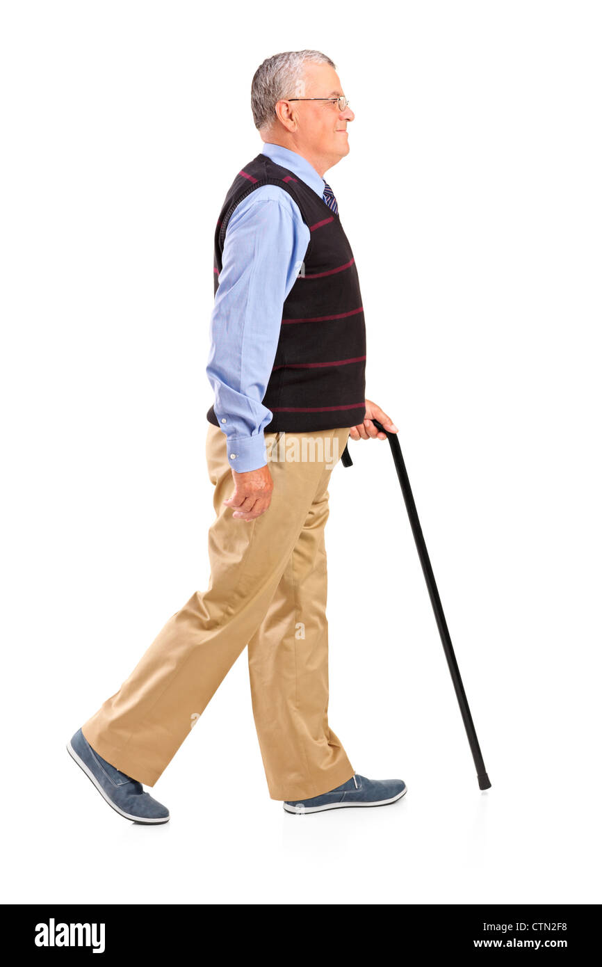 Full length portrait of a senior man walking with cane isolated on ...