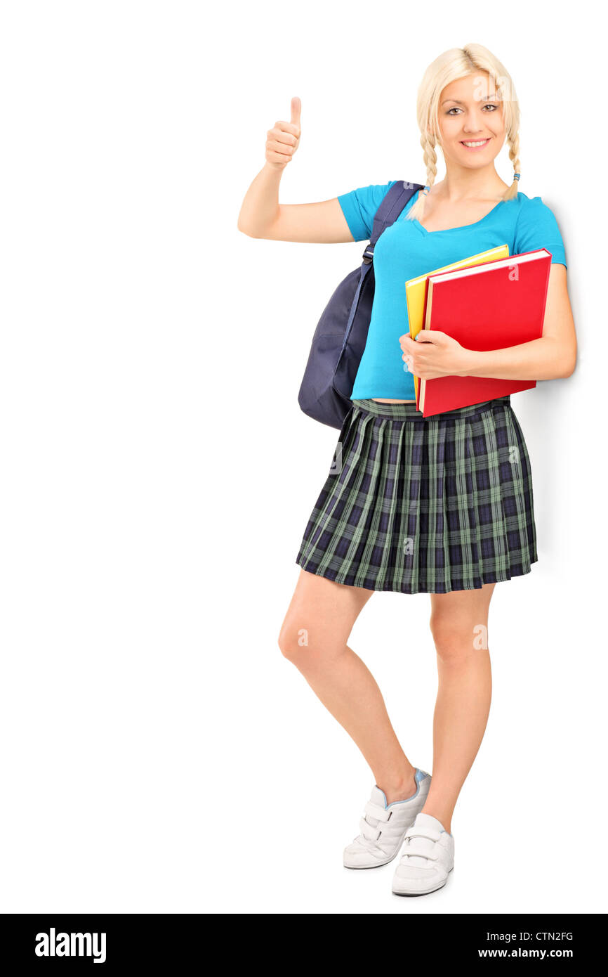 Full length portrait of a female student giving a thumb up, isolated on ...
