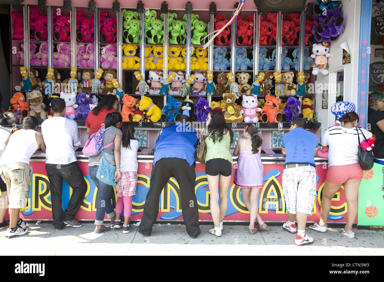 People play one of the arcade games at Coney Island hoping to win a