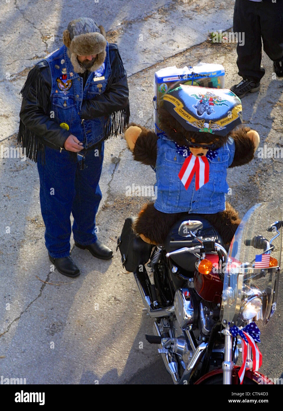 A biker pauses during the Toys for Tots bike run in Chicago next to his bike which is carrying a