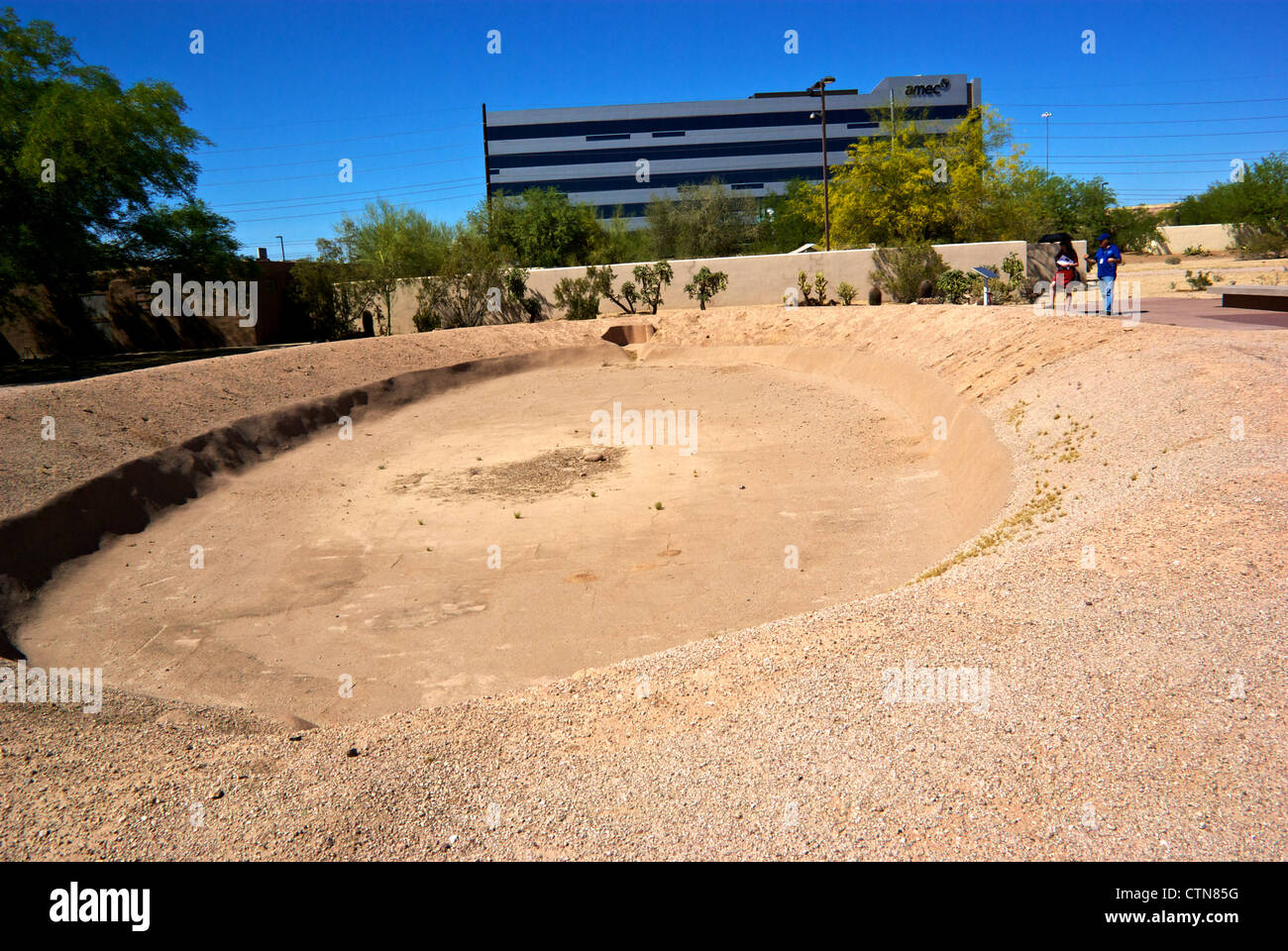 Docent showing visitor Arizona First Nations oval-shaped ballcourt archaeological excavation Pueblo Grande Museum Stock Photo
