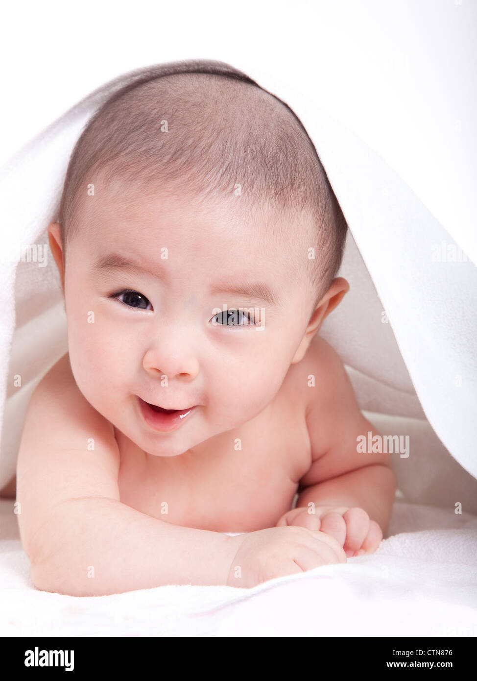 adorable baby lying on the bed Stock Photo