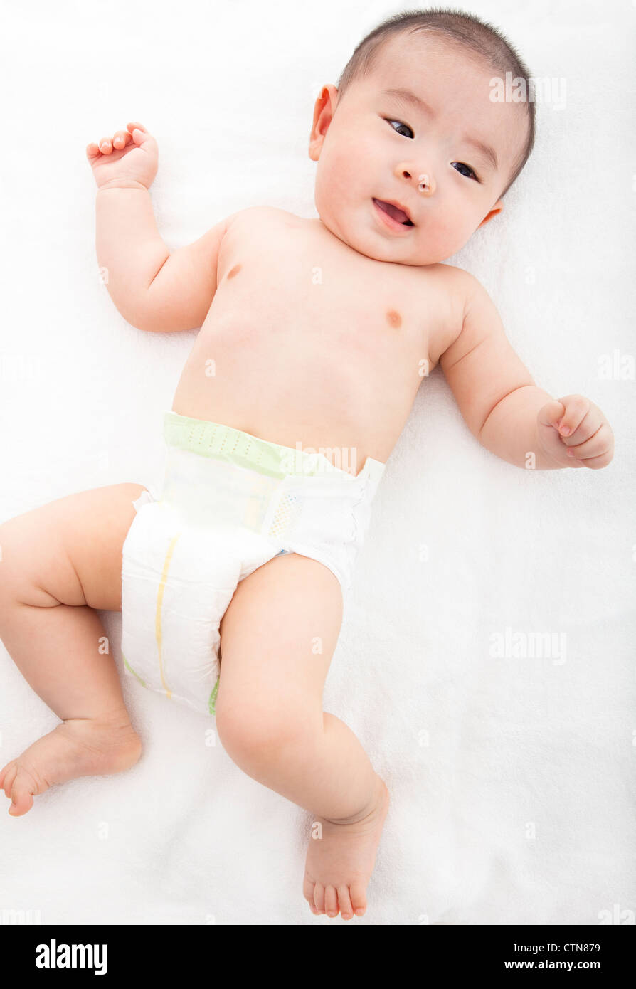 asian baby lying on the bed Stock Photo