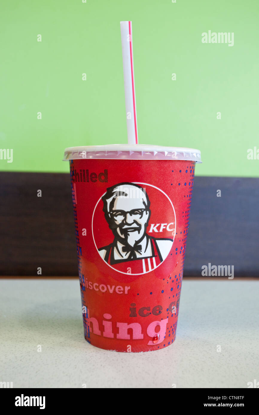KFC soft drink paper cup with a straw in it. Stock Photo