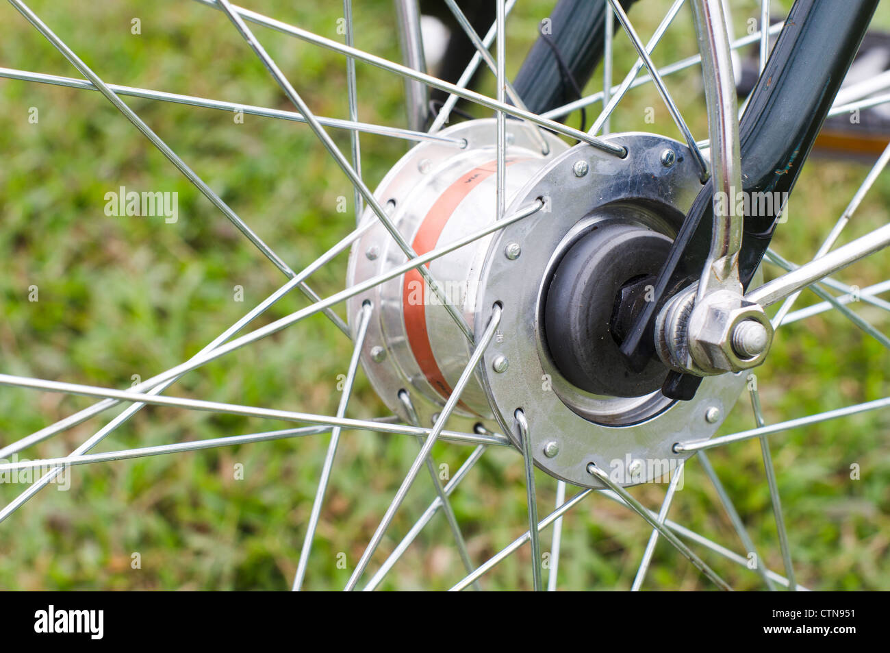 close up look of a hub dynamo of a bike, to generate electricity for bike lighting. Stock Photo