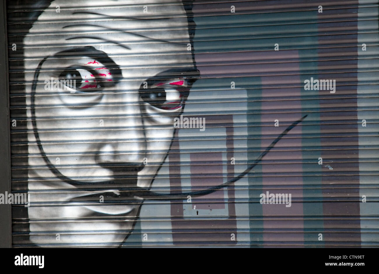 painting of salvador dali face on a  shop shutter , barcelona , spain Stock Photo