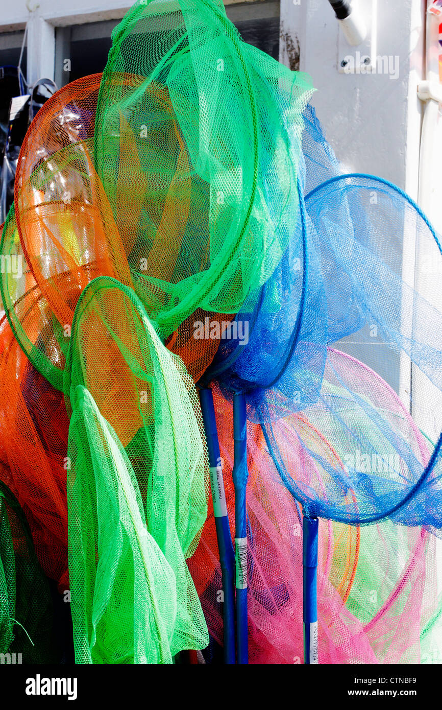 Brightly coloured fishing nets for sale in a seaside kiosk. Stock Photo