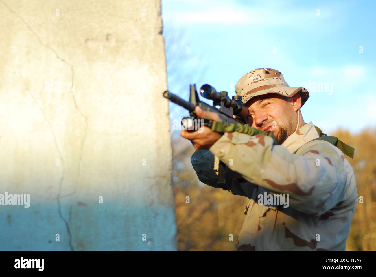 Soldier in camouflage aiming with his rifle outdoor Stock Photo - Alamy