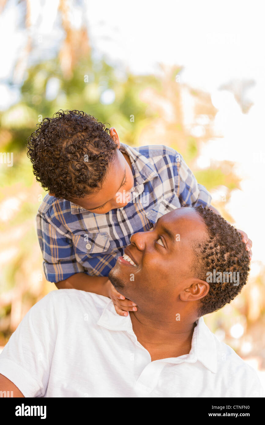 Happy African American Father and Mixed Race Son Playing Piggyback in ...