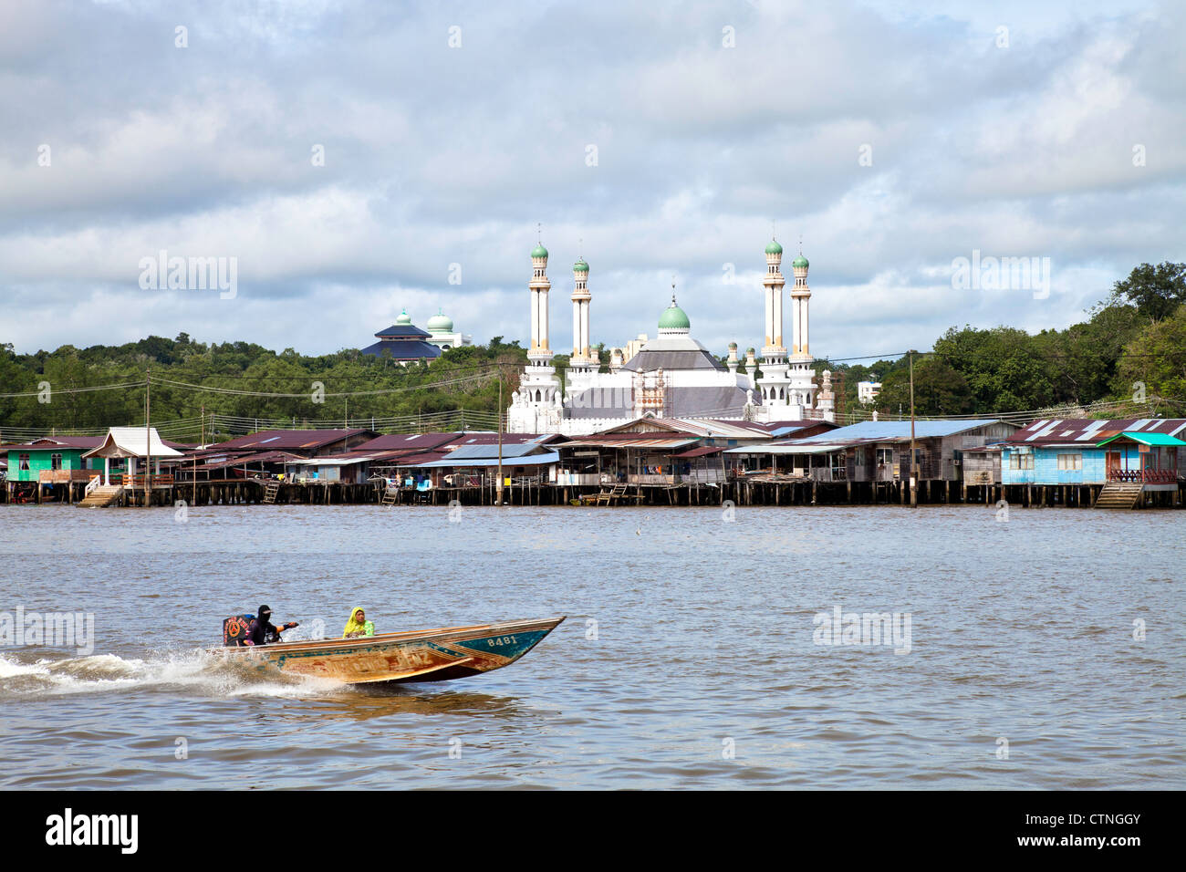 Water taxi with Kampong Ayer and a floating mosque in the background Bandar Seri Begawan Brunei. Stock Photo