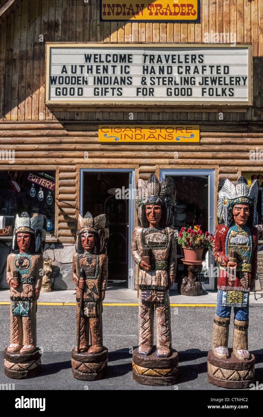 Four hand-carved cigar store wooden Indians are lined up for sale in front of an Old West souvenir shop in Jackson Hole, Wyoming, USA. Stock Photo