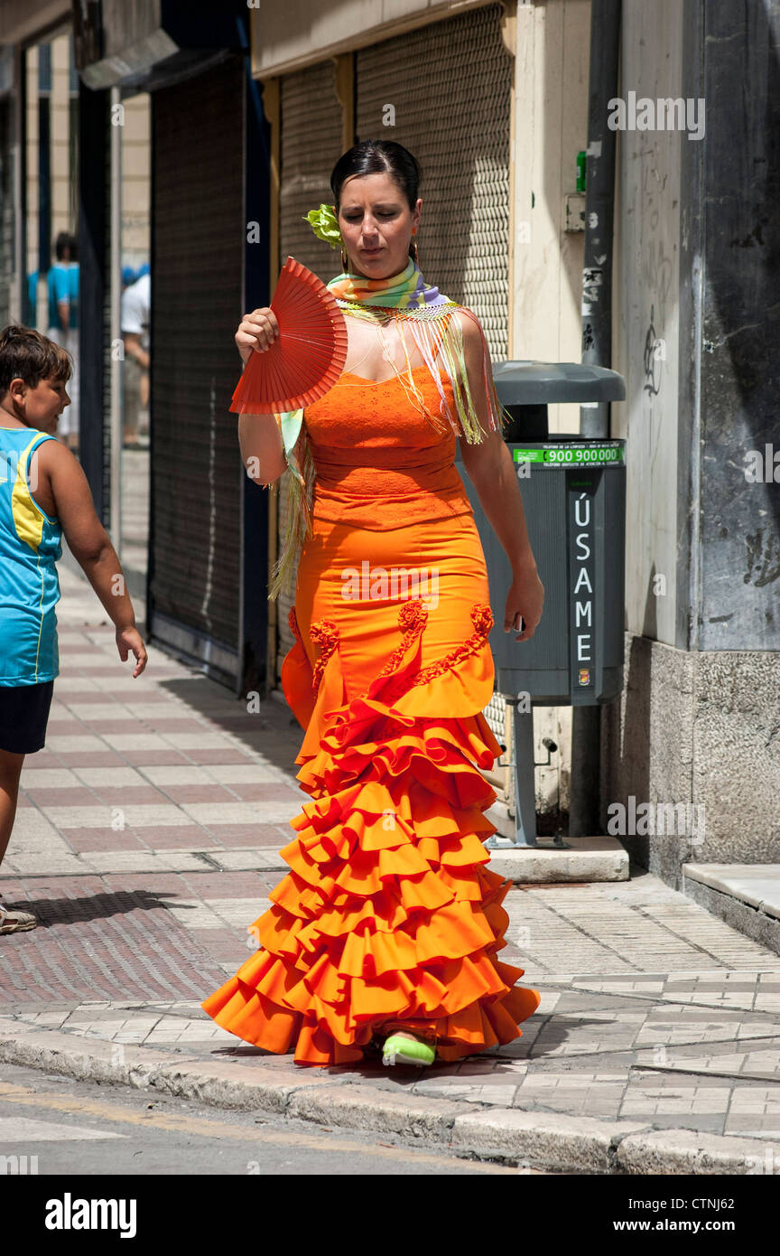 Woman in orange flamenco dress with fan, Spain Stock Photo - Alamy