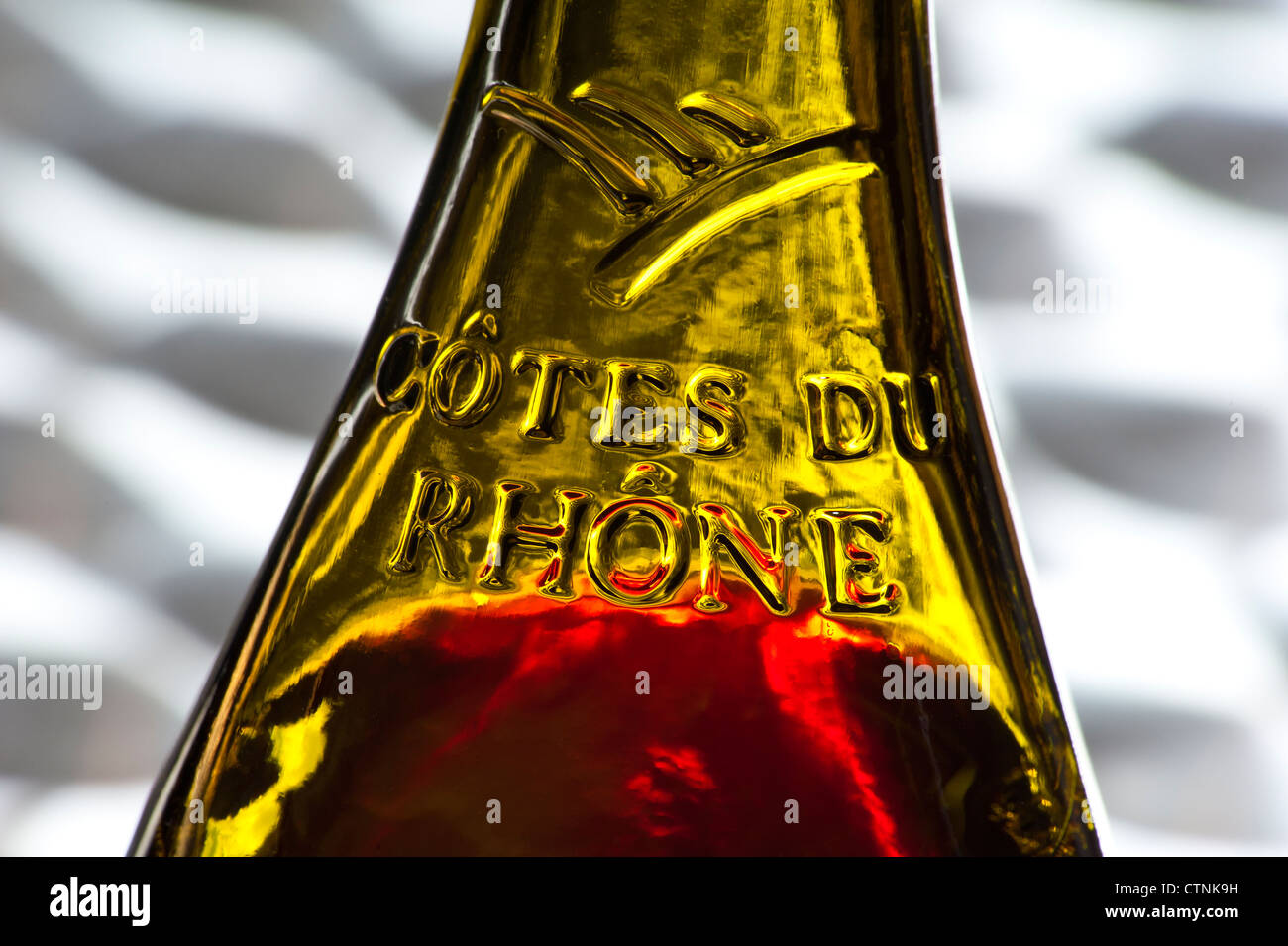 Close view on the glass relief label on a bottle of French Cotes du Rhone red wine Stock Photo