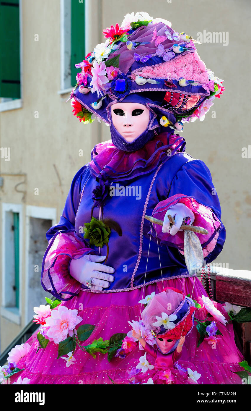 Masked participant during Carnival on Burano Island, Venice Stock Photo