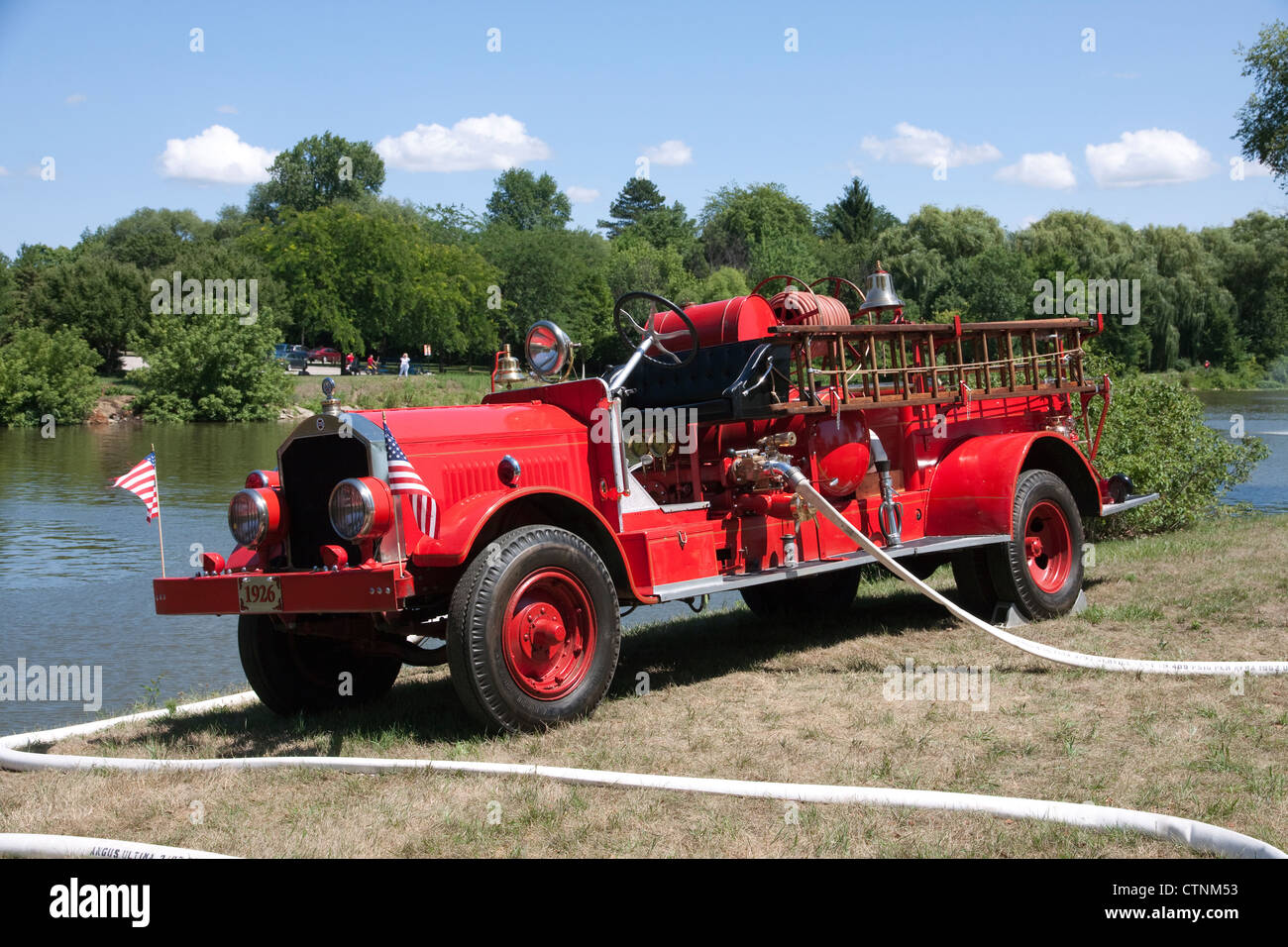 1926 Childs Fire Engine Pumper pumping drafting and pumping water along the Cass River, Frankenmuth, Michigan USA 2012 Stock Photo