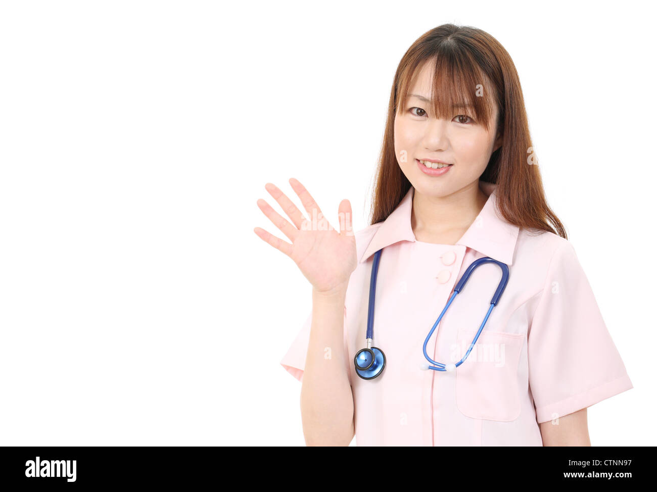 Young asian female nurse waving hand Stock Photo