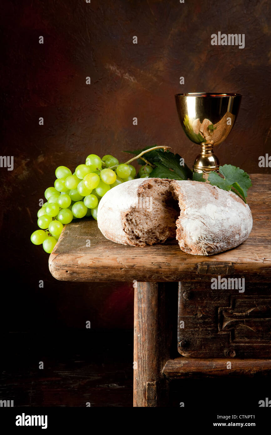 Sacred wine chalice with grapes and holy bread Stock Photo Alamy