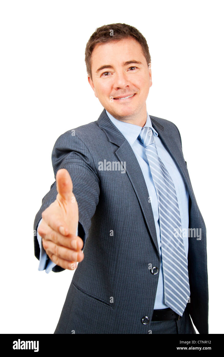 Confident business man holding out hand in friendly hand shake gesture on isolated background Stock Photo