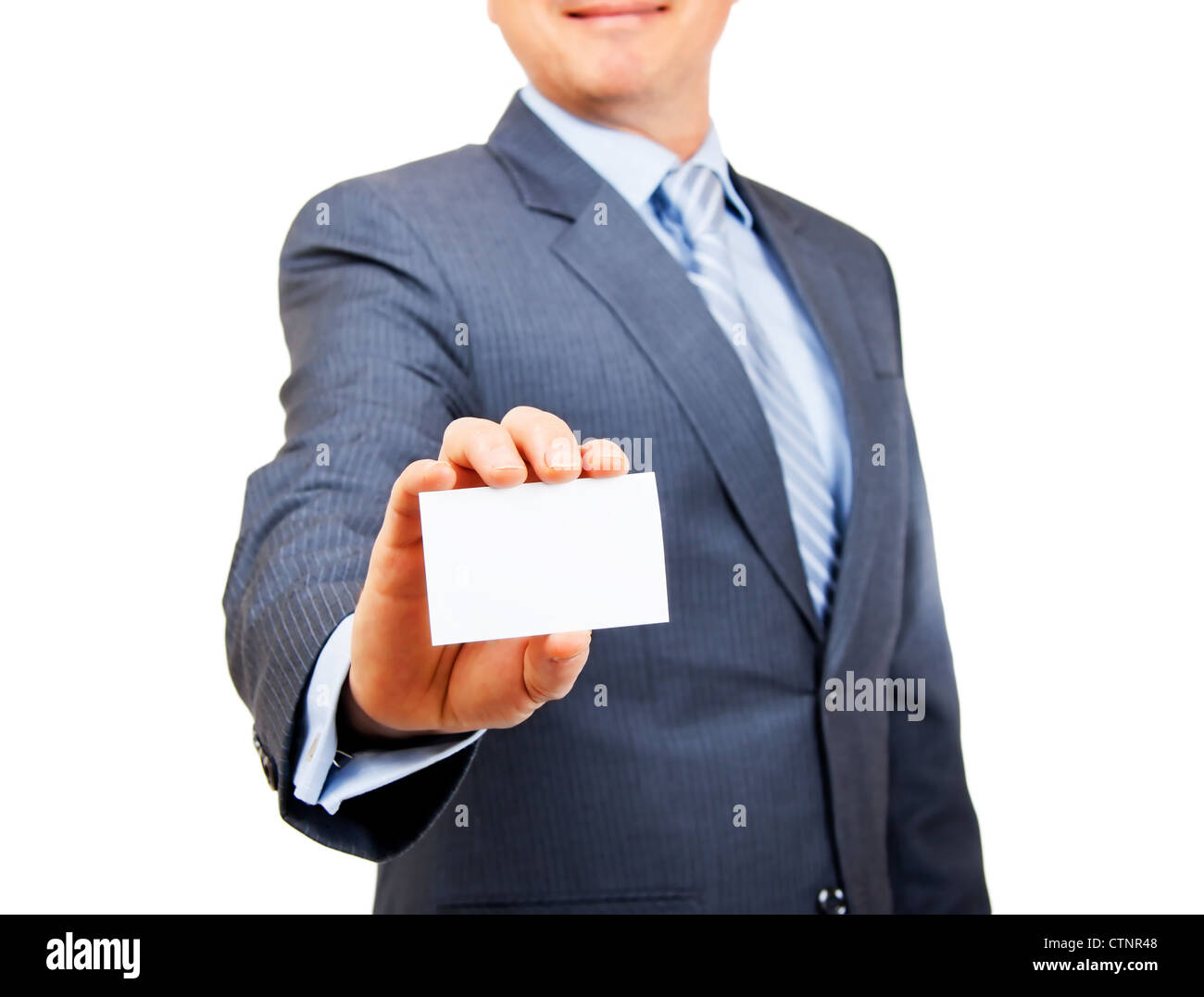 Business person in suit holding out blank white copy space card on isolated background. Focus on card. Stock Photo