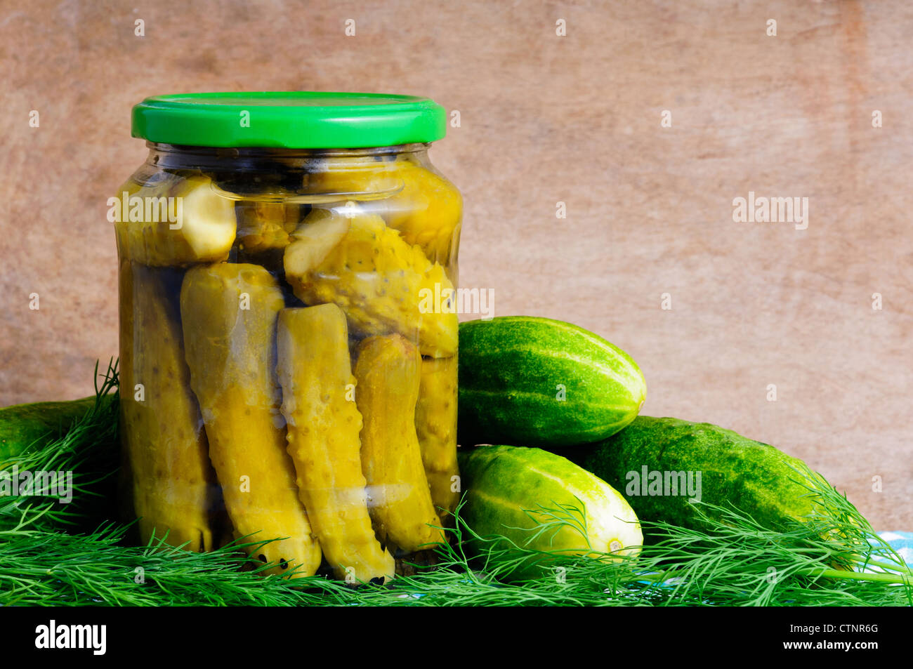 homemade pickles and cucumber with dill on a wooden background Stock Photo