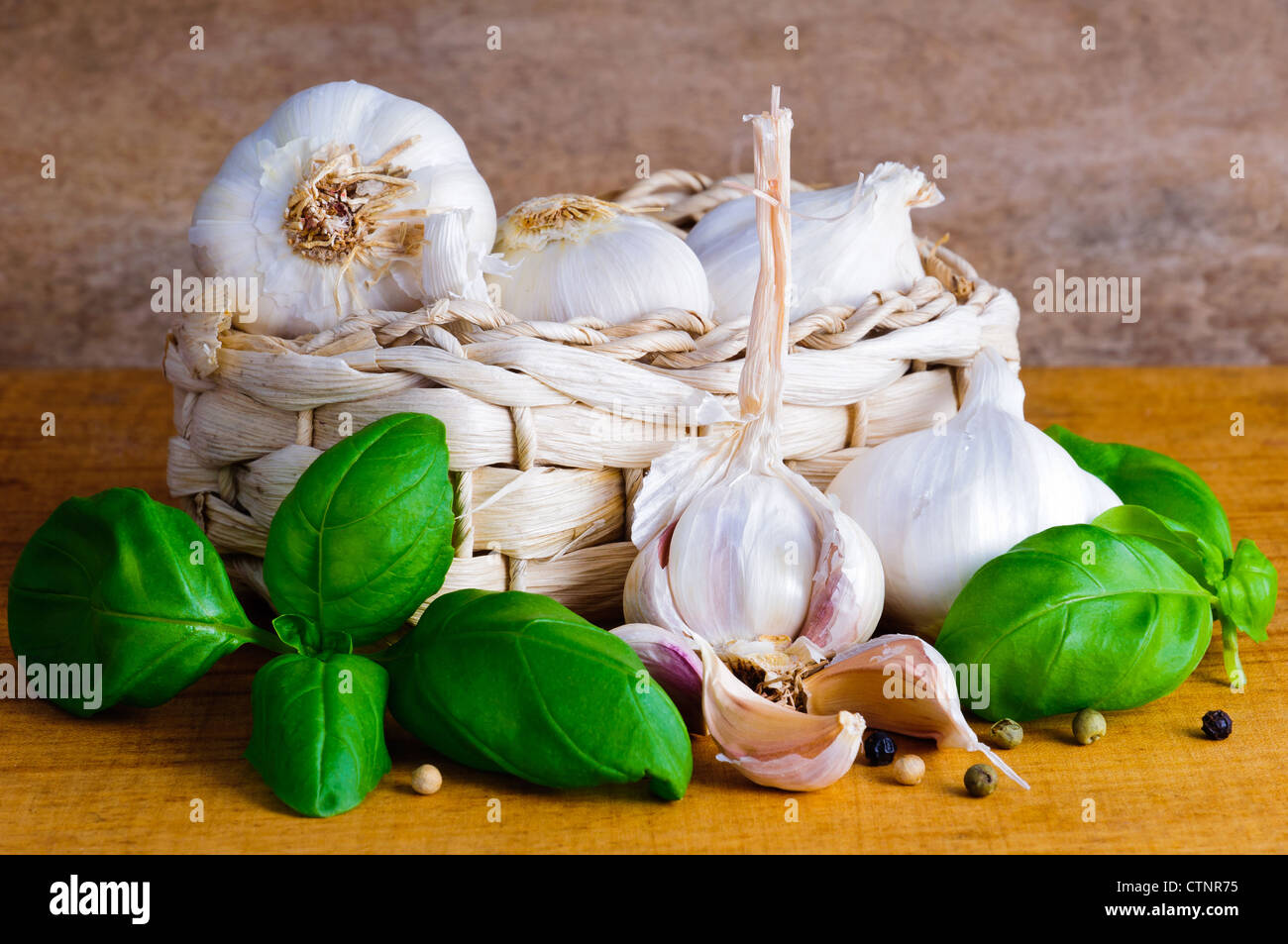 Still life with organic garlic and basil Stock Photo