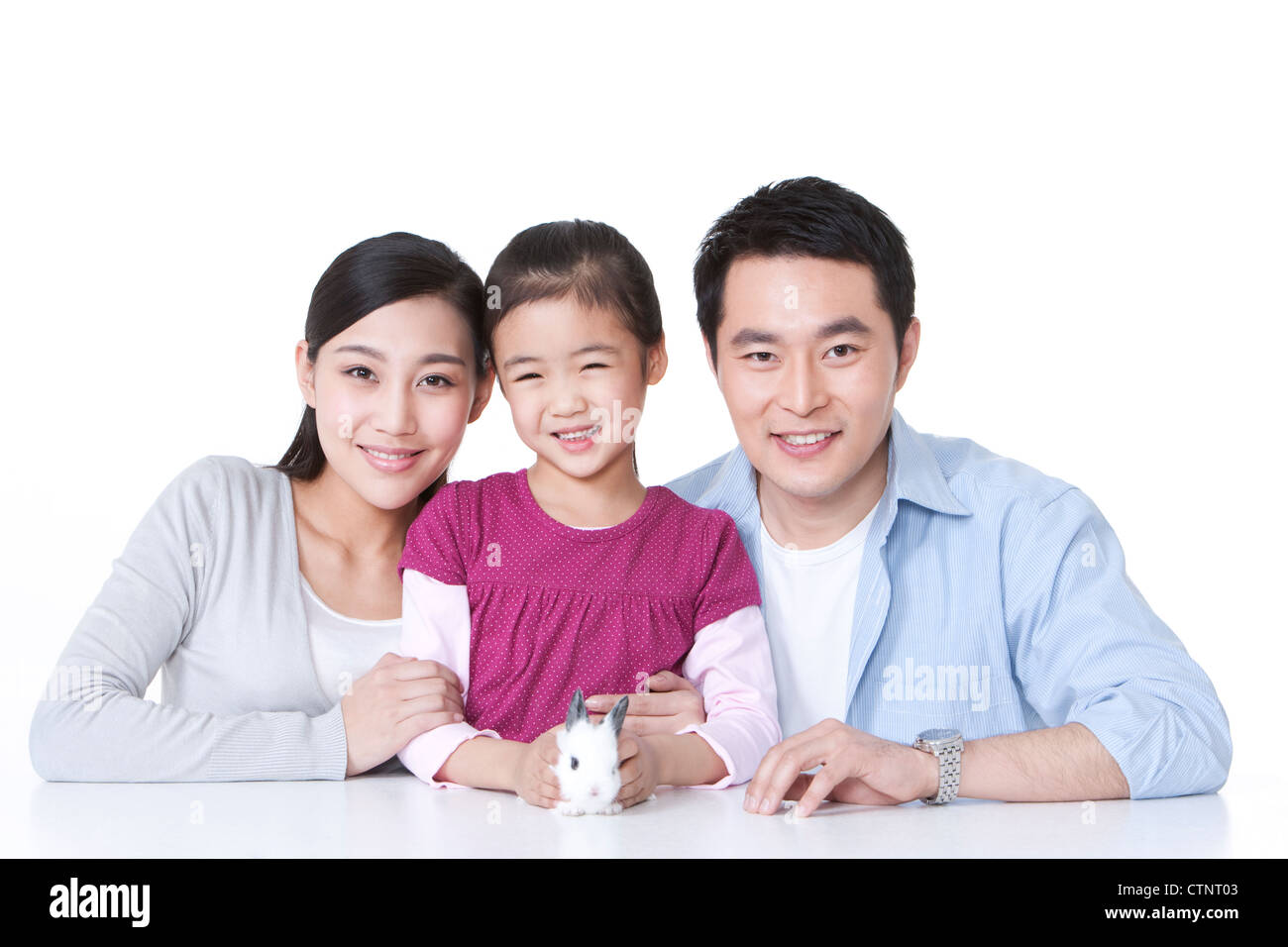 Happy family with pet rabbit Stock Photo - Alamy