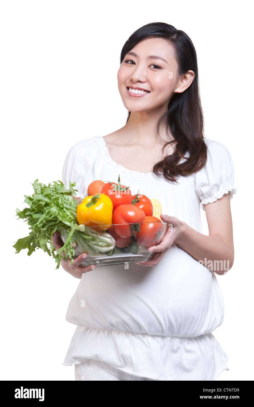 Pregnant woman holding a bowl of fresh vegetables Stock Photo - Alamy
