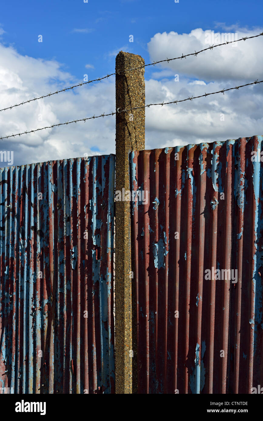 Corrugated Iron Fence With Concrete Post And Barbed Wire London Stock 