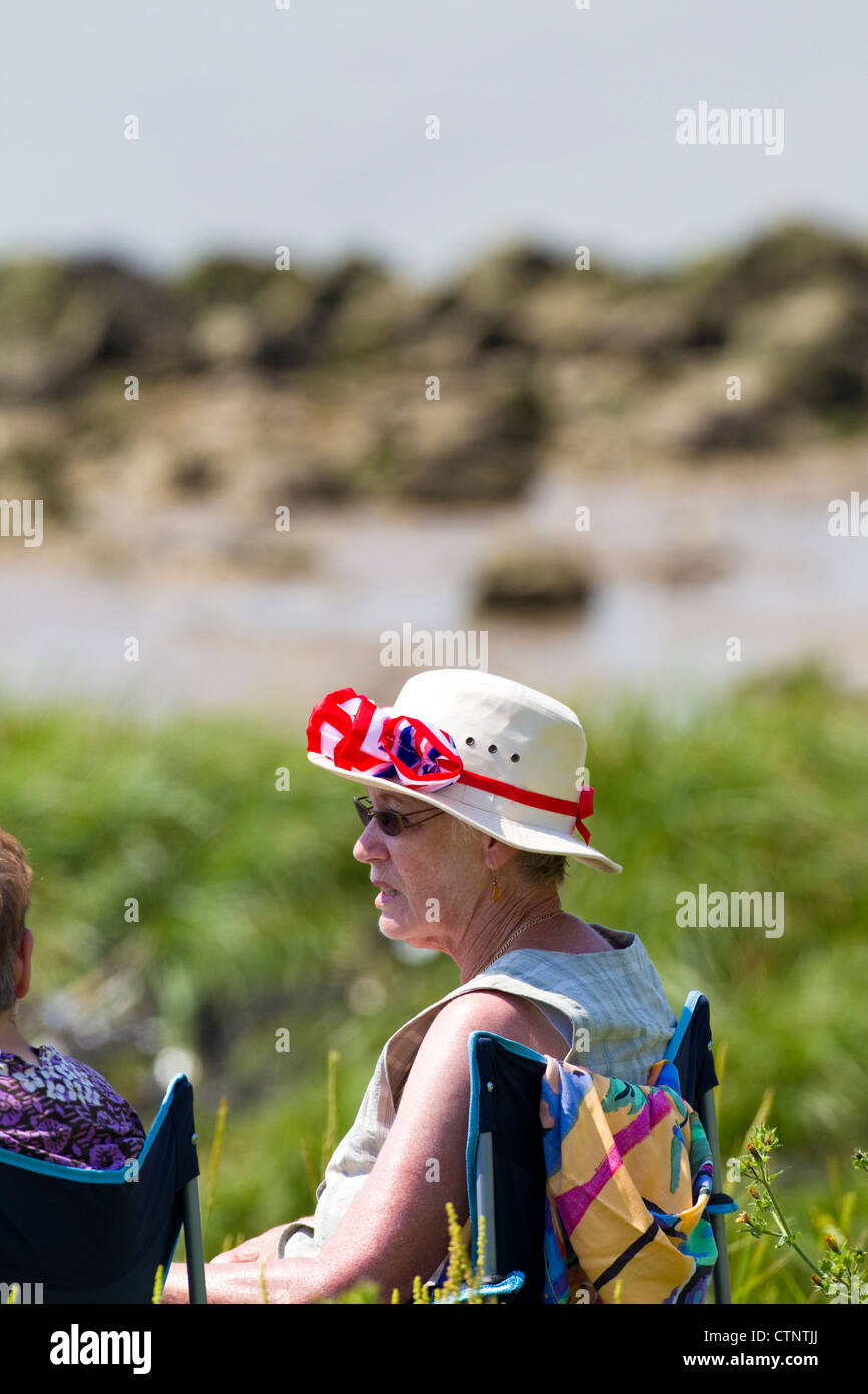 Lady waring colourful hat with union flag ribbon, London, UK Stock Photo