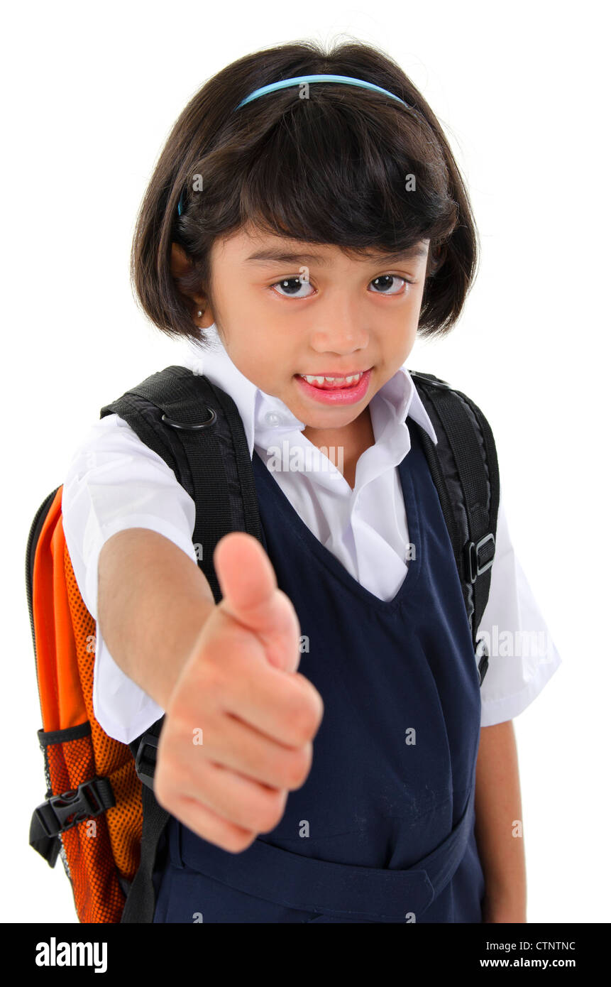 Thumb up Southeast Asian primary school girl with backpack on white background Stock Photo