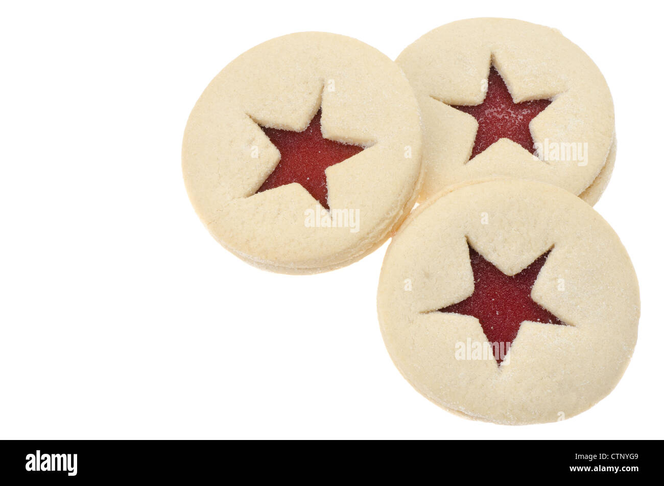 Three Linzer tarts with a jam centre, positioned to allow for copy space - studio shot with a white background Stock Photo