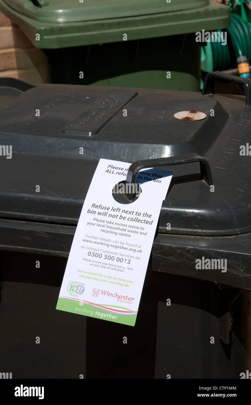 Refuse bin Local Authority label giving instructions on excess waste which may not be left outside of the container Stock Photo