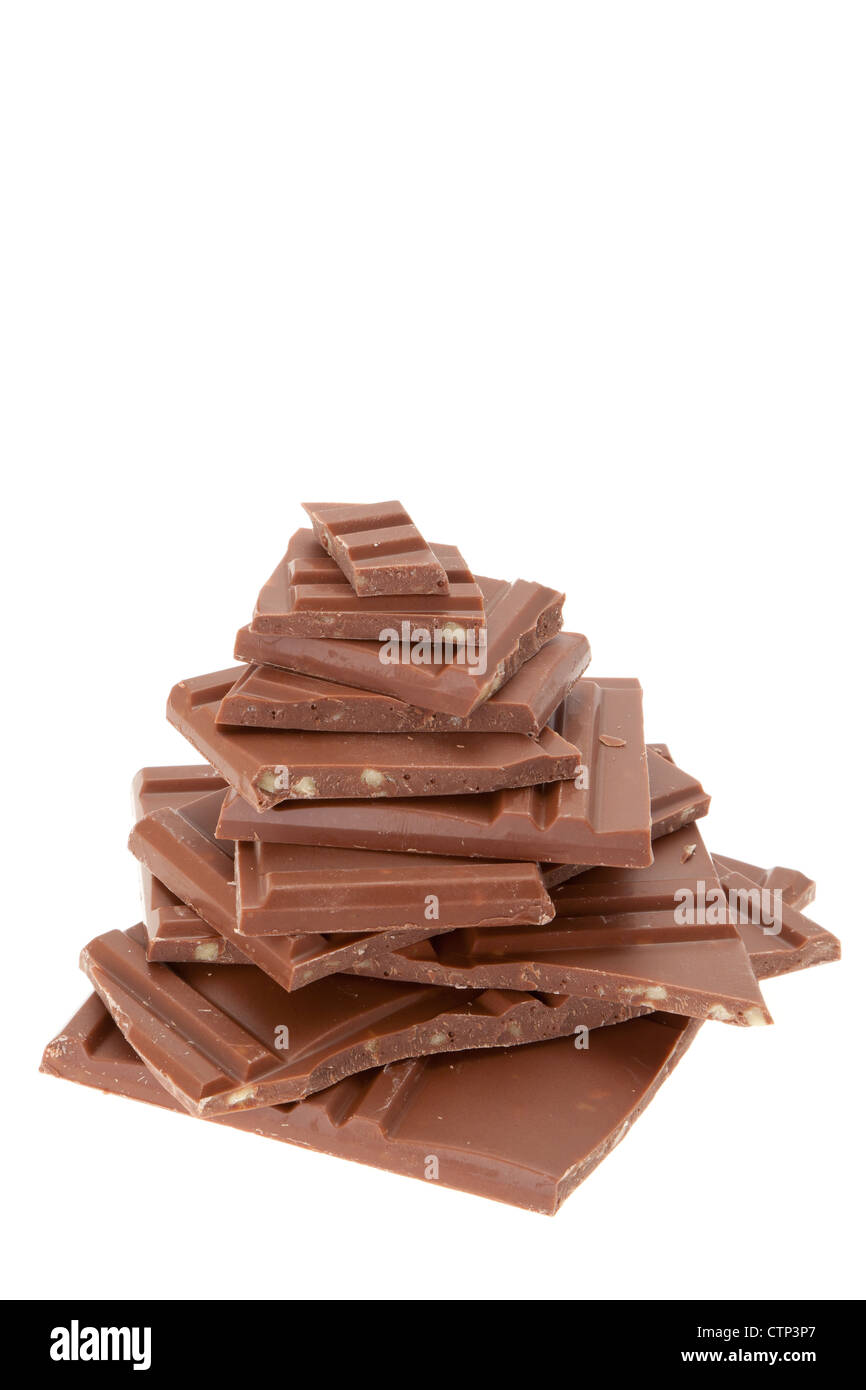 Slices of milk chocolate placed in a stack - studio shot with a white background Stock Photo