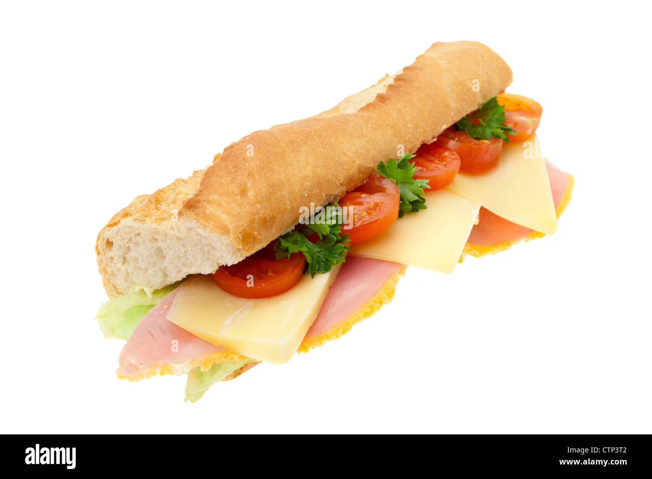 A fresh ham, cheese and salad sandwich in a French baguette studio shot with a white