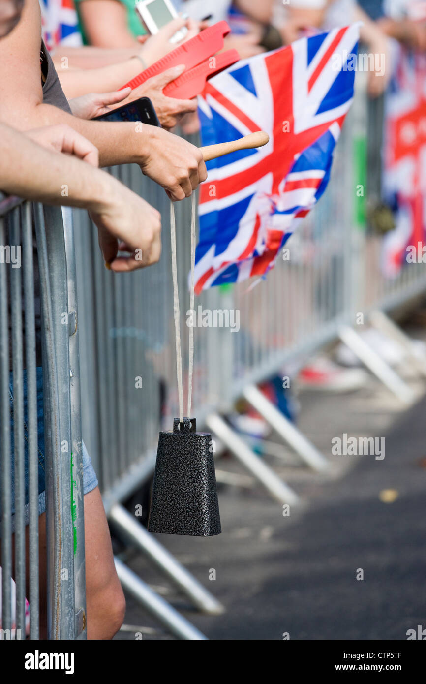 London 2012 Olympics. Spectators with Union Jack and cowbell at men's cycle road race. Stock Photo