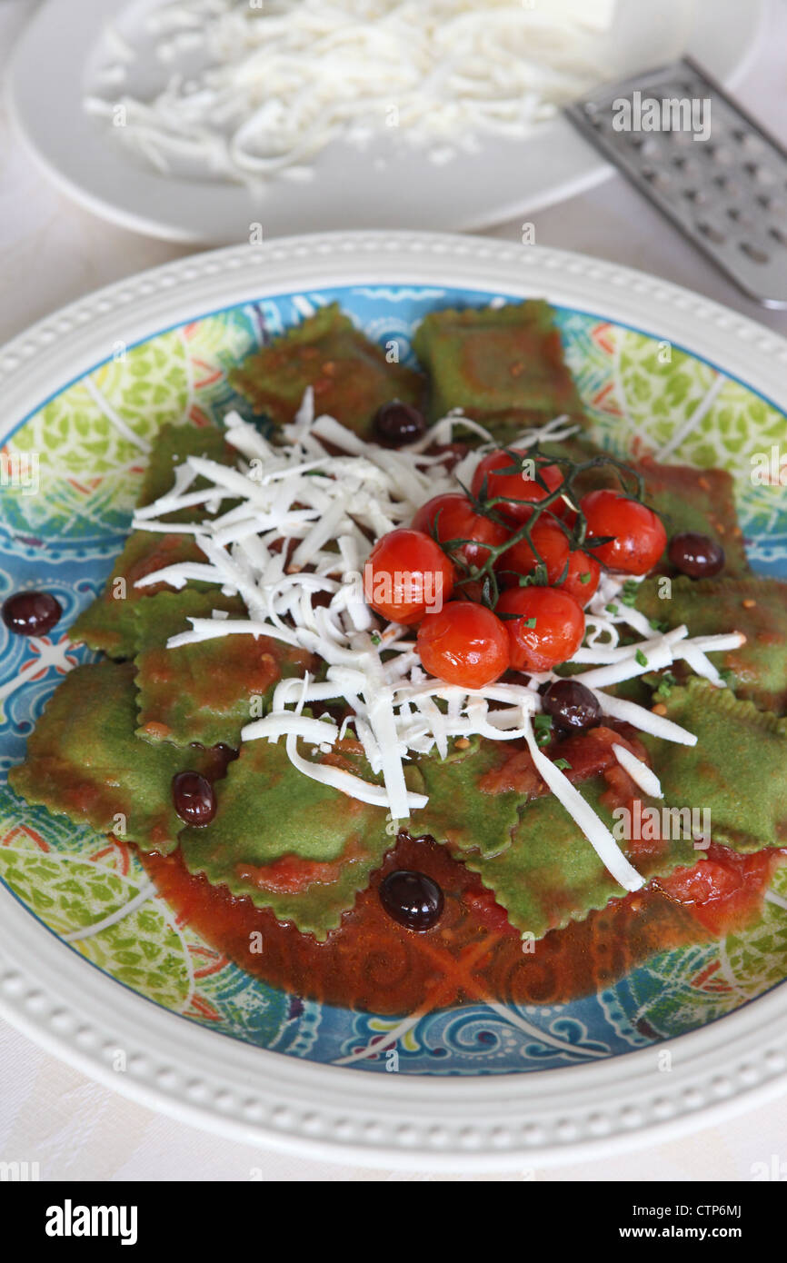 A plate of freshly cooked spinach flavoured ravioli (stuffed pasta) Stock Photo