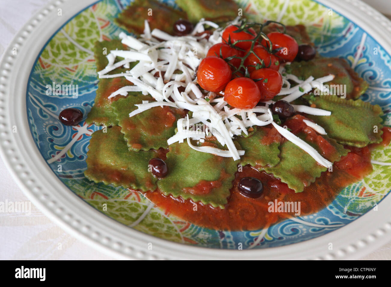 A plate of freshly cooked spinach flavoured ravioli (stuffed pasta) Stock Photo