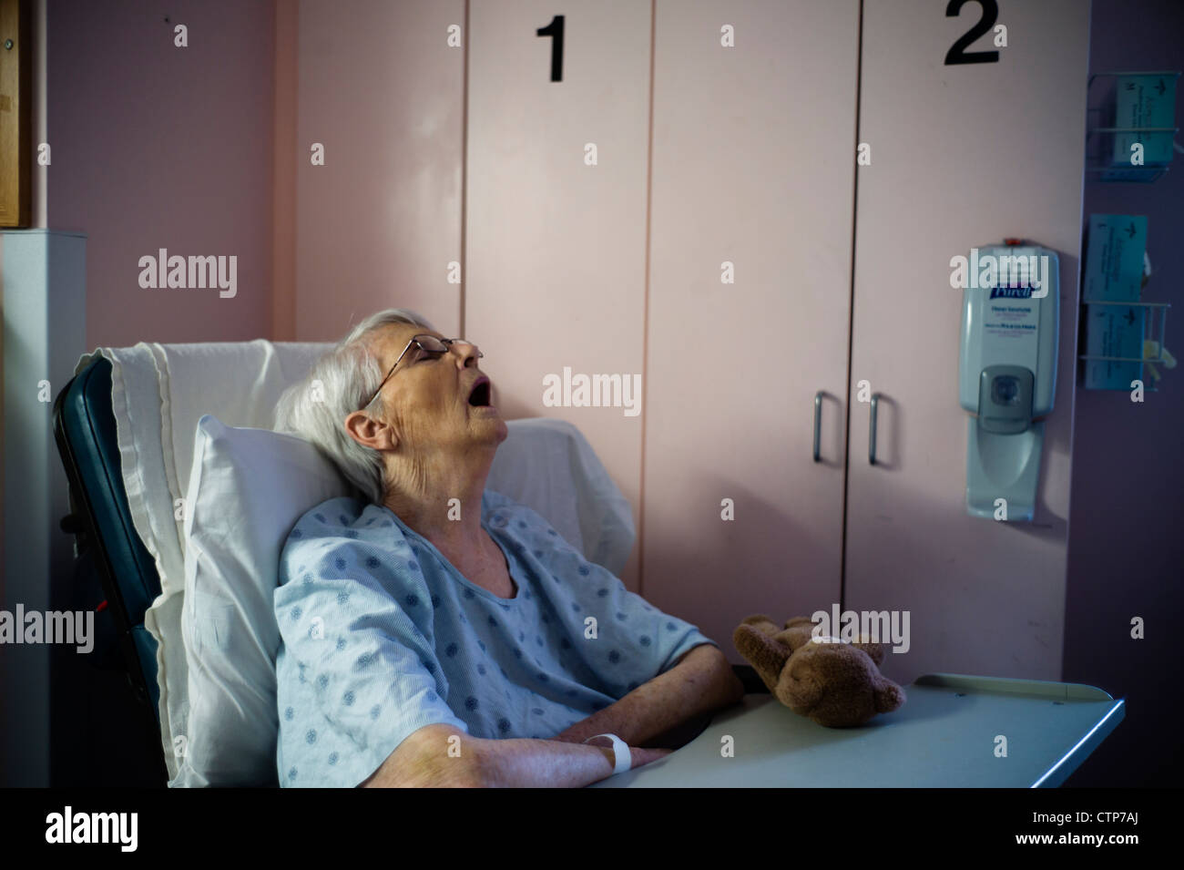 Old woman asleep propped up in hospital bed Stock Photo Alamy