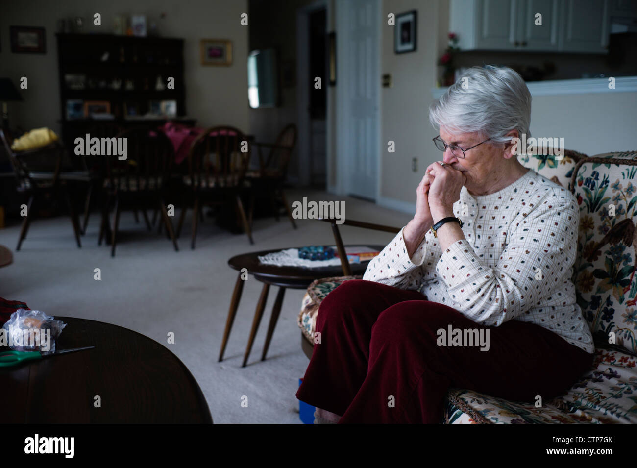 Old woman sitting in chair. Stock Photo