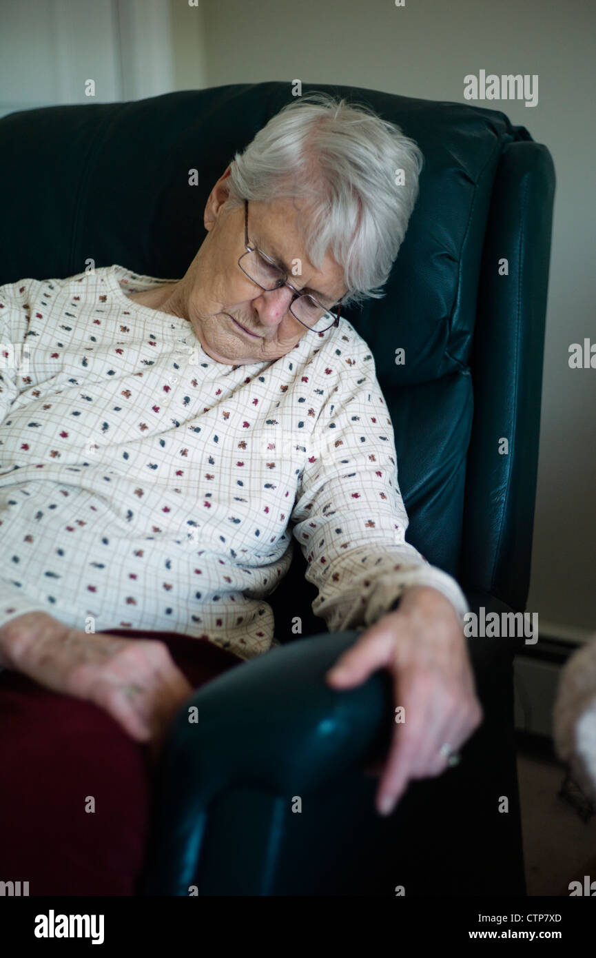 Old woman slumped over asleep in chair Stock Photo - Alamy