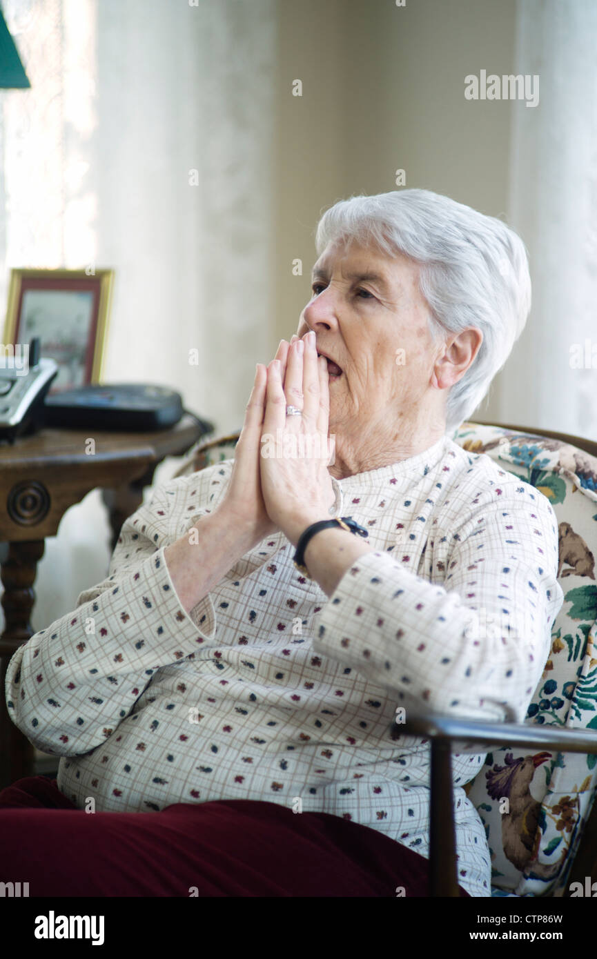 Old woman sitting in chair Stock Photo - Alamy